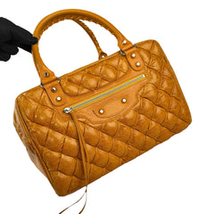 balenciaga quilted mustard yellow leather matelasse handbag left front 45